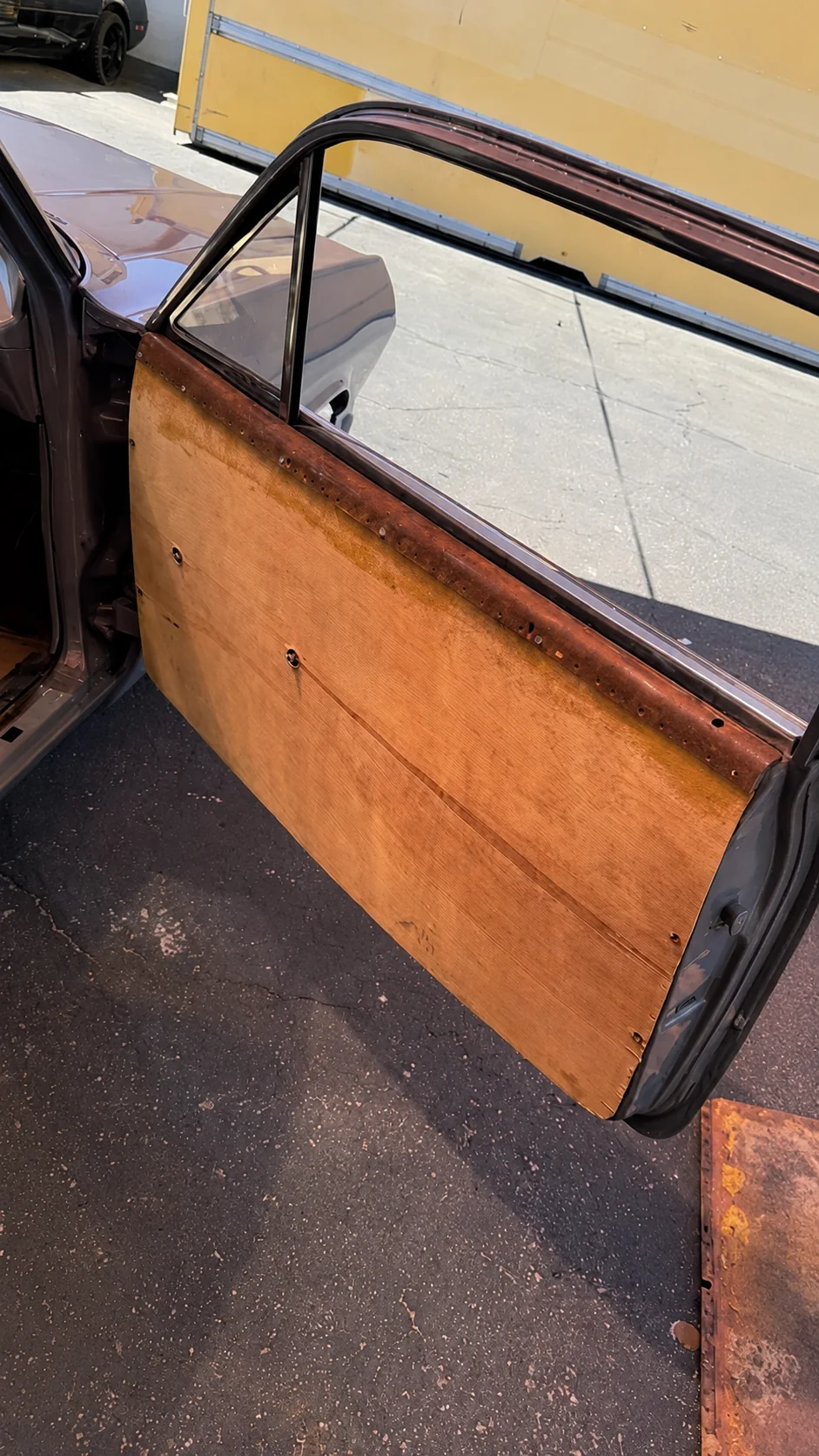 Classic vehicle door stripped to its bare backing