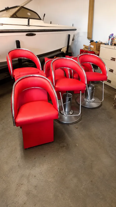 Set of red salon chairs with chrome frames