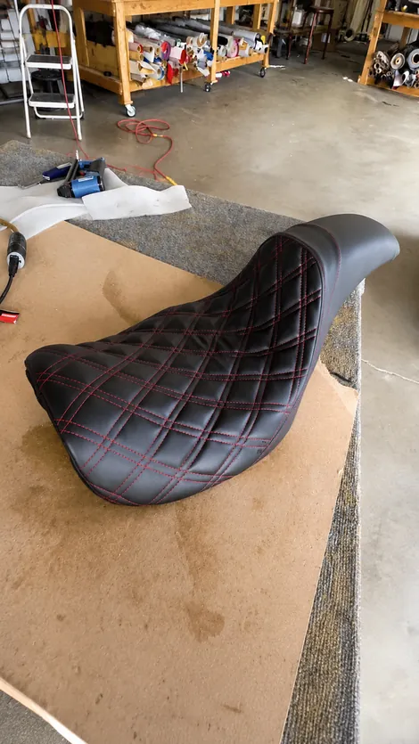 Diamond-stitched motorcycle seat with red thread